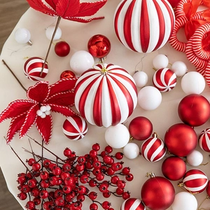 Red and white Christmas candy theme ornaments set with baubles and festive berries
