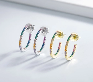 Detailed macro view of 925 silver C-shape earrings with colorful zircon stones
