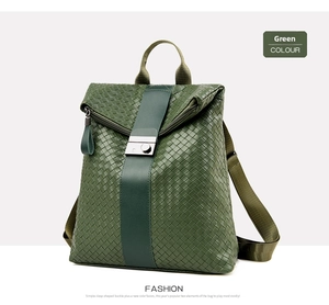 Detail of green woven leather backpack featuring silver metal buckle and handle