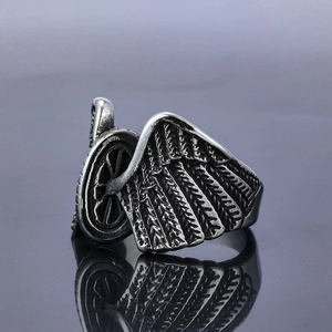 Vintage stainless steel motorcycle ring featuring detailed silver wing design on mirror base
