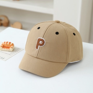 Detail of khaki cotton baseball cap showing P letter embroidery and breathable eyelets