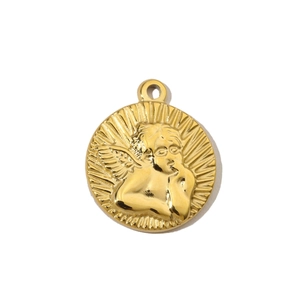 Macro view of a circular gold stainless steel pendant with embossed angel detail
