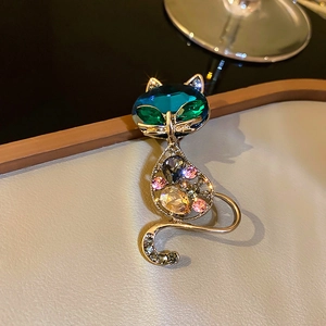 Macro shot of cat brooch with multi-colored crystals on a gold alloy base detail