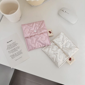 Close-up of pink and cream heart quilted mini pouches with silver snap closure