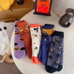 Set of five plush Halloween crew socks featuring pumpkin and ghost patterns on white fur