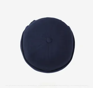 Top view of a dark blue cotton docker cap featuring a six-panel stitch and top button