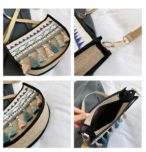 Detail of bohemian woven jute bag showing geometric embroidery, tassels, and gold hardware