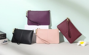 Close-up of litchi texture PU leather wristlet bags in black, pink, purple, and burgundy