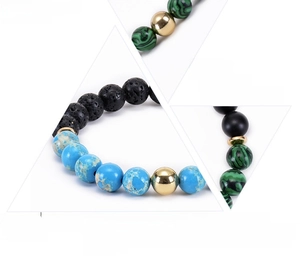 Detailed macro view of malachite and lava stone beads with polished gold spacers