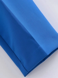 Vista detallada de pantalones azules de cintura alta que muestra la textura de la tela
