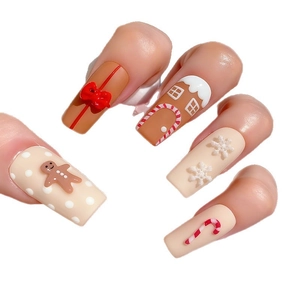 Christmas press-on nails with 3D gingerbread man, snowflake, and bow design in matte finish