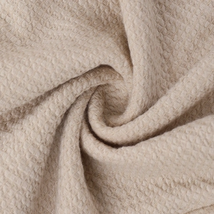 Macro shot of the beige waffle texture fabric on this elegant bodycon evening dress