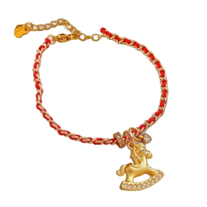 Red braided rope bracelet with golden rocking horse pendant and sparkling zircon accents