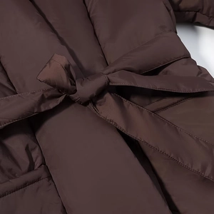 Women's dark brown oversized quilted jacket with v-neck and waist-tie belt detail