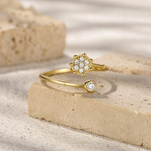 Detail of gold open ring featuring a hexagonal crystal cluster and single round solitaire