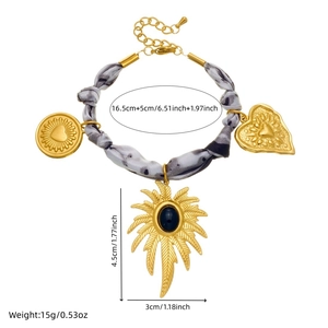 Golden chain bracelet with heart pendants and grey ink-style ribbon on white background