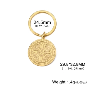 Macro shot of gold stainless steel keychain with detailed Celtic knot and rune engravings