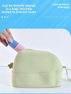 Putting a leakproof silicone travel bottle into a green toiletry bag for storage