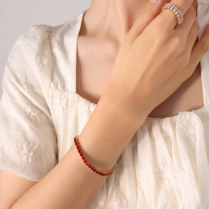 Elegant 18K gold-plated titanium bracelet with red zircon and white diamond ring on model