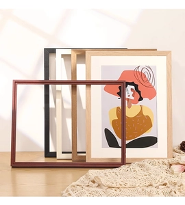 Detail of solid wood photo frames in red, black, and white for home gallery decor