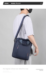 Navy nylon business bag shown being worn on the shoulder with a strap and handle