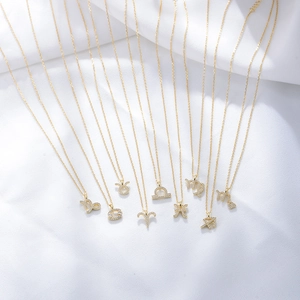 S925 silver gold zodiac pendant necklaces with crystals on white fabric background