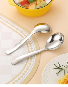 Macro detail of food-grade 316L stainless steel engraving on polished round spoons