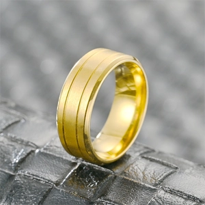 Macro shot of gold-plated titanium ring featuring brushed finish and dual parallel grooves