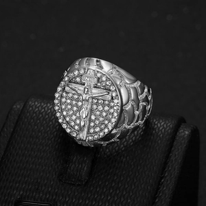 Macro shot of silver hip hop ring with Jesus relief, INRI text, and sparkling zircons