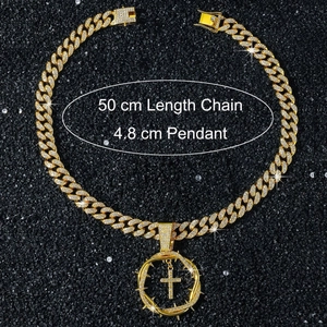 Detailed view of a 50cm golden iced-out cuban chain and 4.8cm thorn cross pendant
