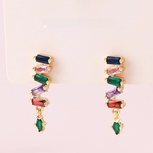 Detail of gold earrings with colorful rectangular stones on a jewelry display card
