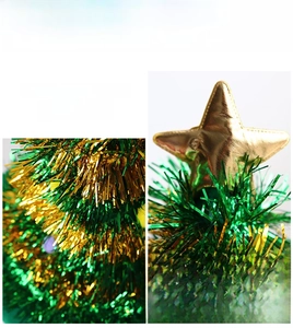 Detail of green and gold tinsel foil fringe with a golden star topper for Christmas hats