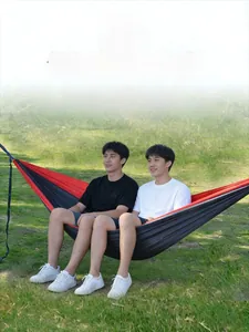 Outdoor camping hammock in red and black parachute nylon featuring a double capacity design