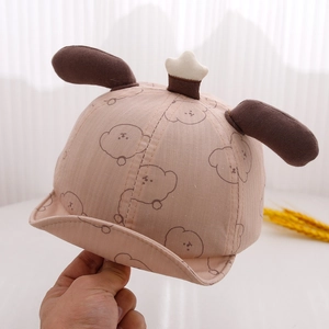 Close-up of pink cotton baby cap featuring cute bear patterns and 3D ears detail