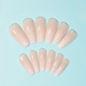 Macro detail of 12-piece nude skin tone glossy coffin shape press-on artificial nails