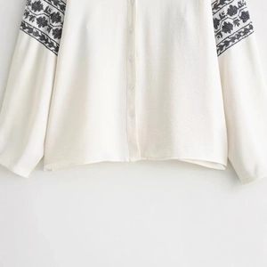 Elegant white blouse for women featuring ethnic black embroidery on long sleeves