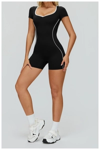 Front detail of black athletic bodysuit featuring white contrast trim and U-neckline