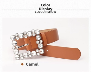 Detail of camel leather belt featuring a large square buckle encrusted with white rhinestones