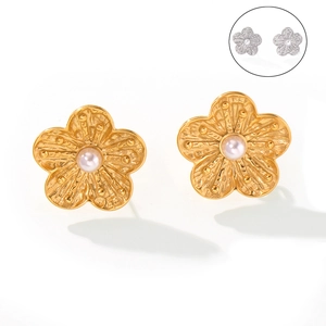 Elegant floral stud earrings with metal petals and a pearl center in gold and silver