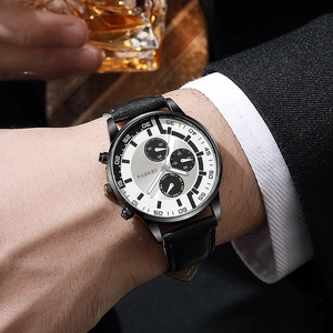 Close-up of men's business watch with white dial, leather strap, and decorative subdials