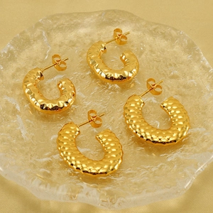 Golden crescent stud earrings featuring a vintage hammered texture and metallic finish