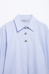 Detail of light blue striped shirt collar with three unique decorative front buttons