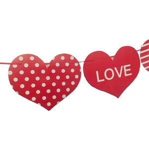 Detail of red heart banner with white polka dots and LOVE text for wedding decor