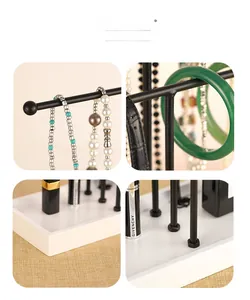 Detailed views of a 3-tier black metal jewelry rack with a white base tray organizer