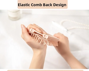 Detail showing the flexible pink hairbrush back design for scalp massage and hair styling