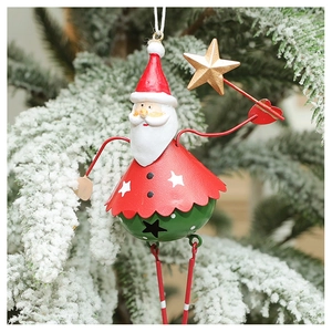 Close-up of Santa Claus iron bell ornament hanging on a snowy Christmas tree branch