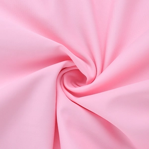 Macro detail of soft pink knit fabric texture with elegant folds and drapery