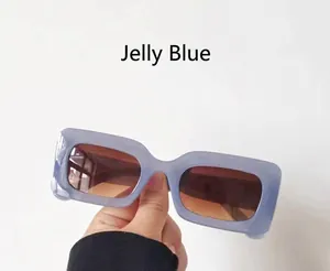 Detail view of jelly blue rectangular sunglasses with brown gradient lenses
