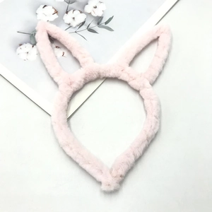 Close-up of pink plush cat ear headband with soft faux fur and fluffy texture detail