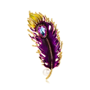 Detail of peacock feather brooch with purple enamel, faceted amethyst and white pearl